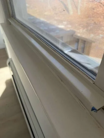 Spotless and restored interior window sill following the completion of the window trim cleaning.