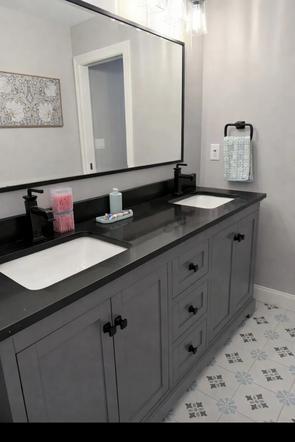 A spotless and organized double vanity featuring clean black faucets and polished countertops after a bathroom deep cleaning.